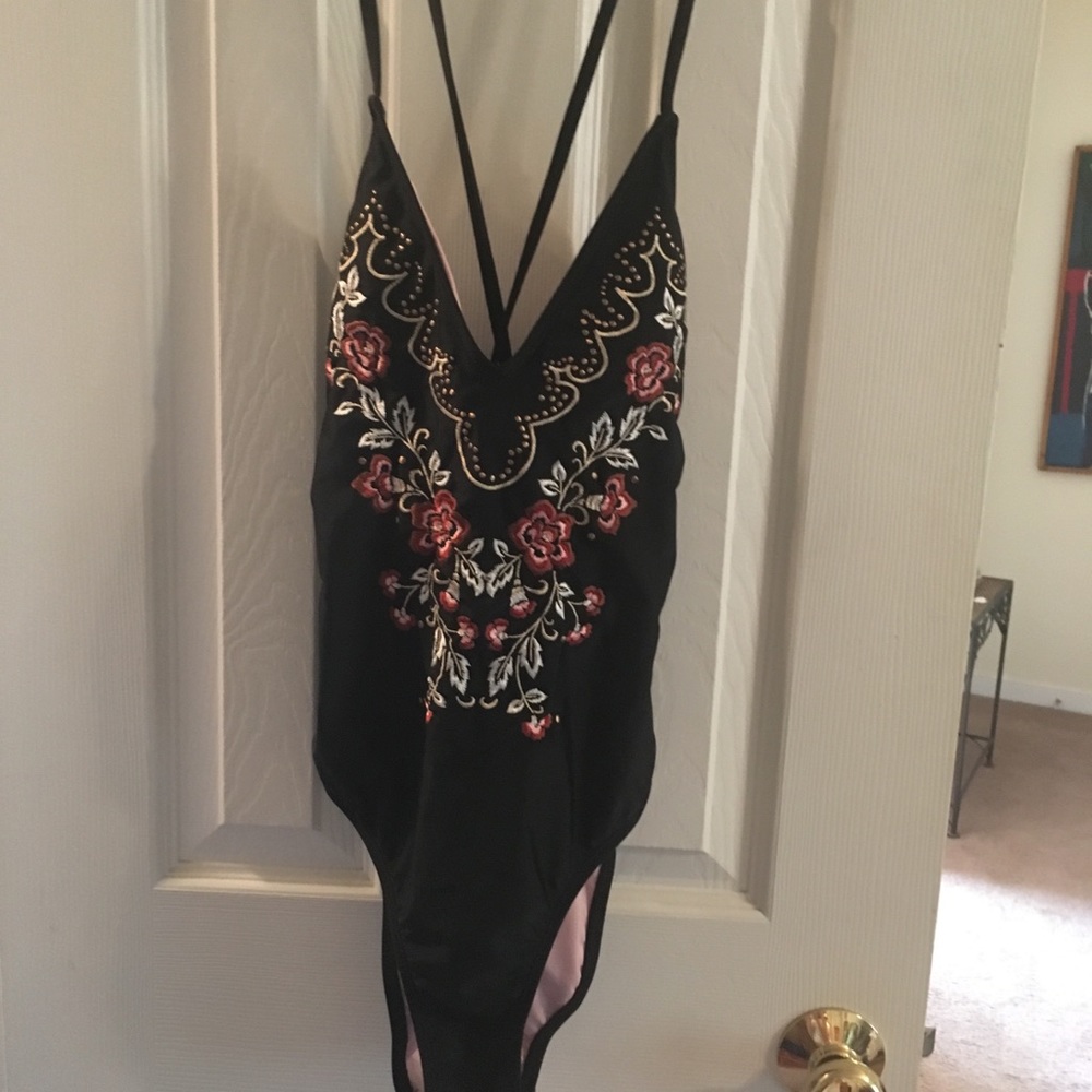 Black one piece with floral print on front